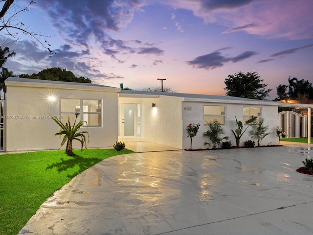 view of front of property with a lawn