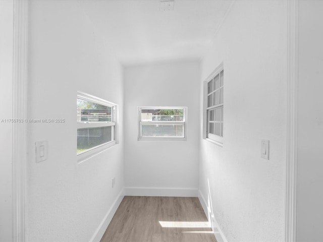 unfurnished room featuring light wood-type flooring and baseboards