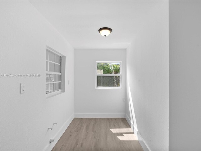 empty room featuring baseboards and wood finished floors