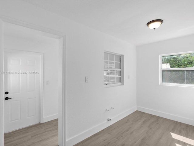 empty room featuring baseboards and wood finished floors