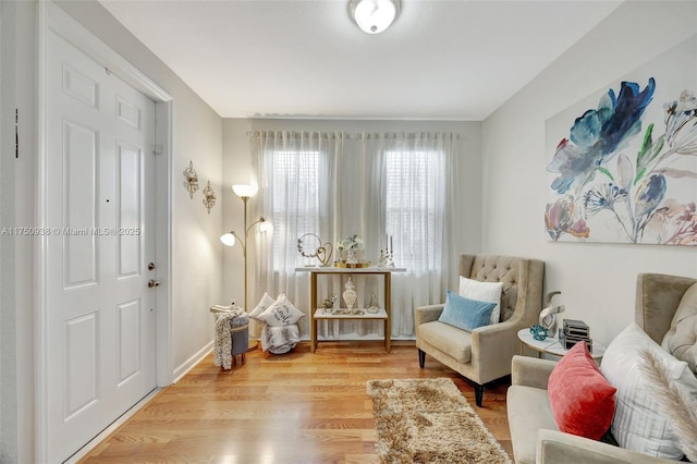 sitting room featuring baseboards and wood finished floors