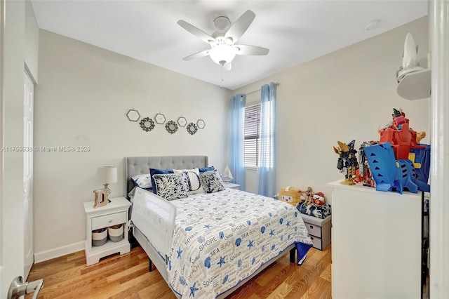 bedroom featuring baseboards, a ceiling fan, and wood finished floors