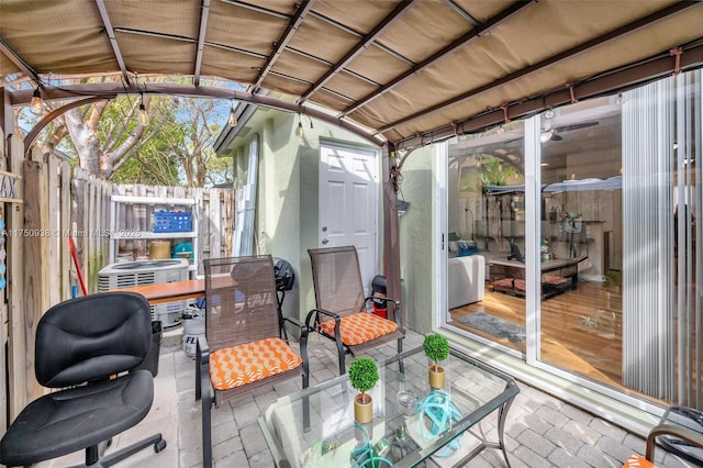 sunroom / solarium featuring lofted ceiling