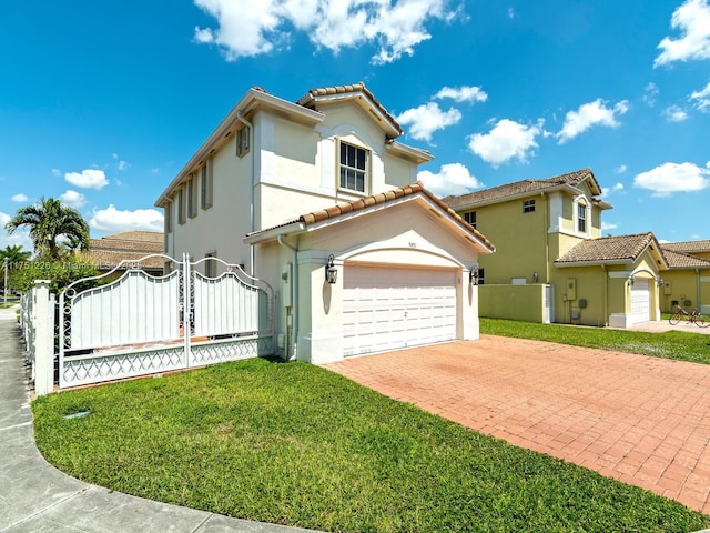 mediterranean / spanish-style house with fence, a tiled roof, stucco siding, decorative driveway, and a gate