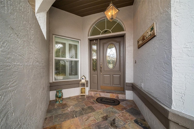 doorway to property with stucco siding