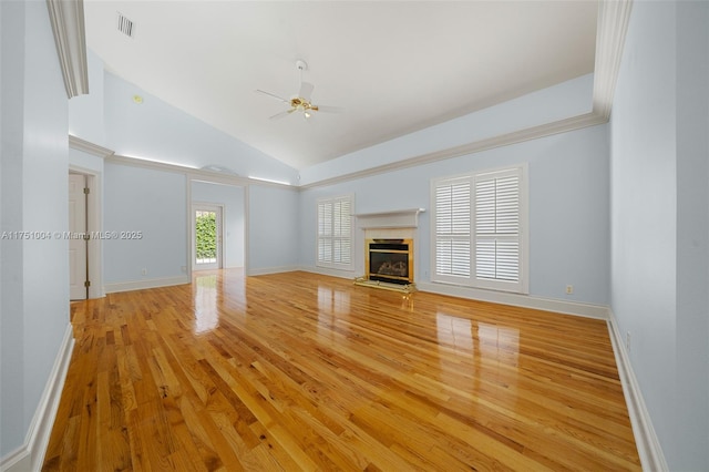 unfurnished living room with visible vents, a premium fireplace, a ceiling fan, light wood-style floors, and high vaulted ceiling