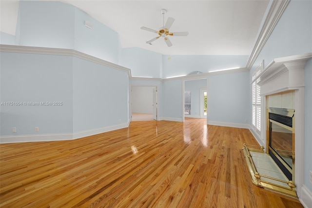 unfurnished living room with a fireplace, light wood-style flooring, ceiling fan, high vaulted ceiling, and baseboards