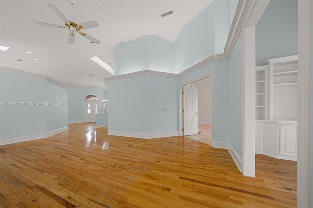 unfurnished living room featuring light wood-type flooring, high vaulted ceiling, baseboards, and visible vents