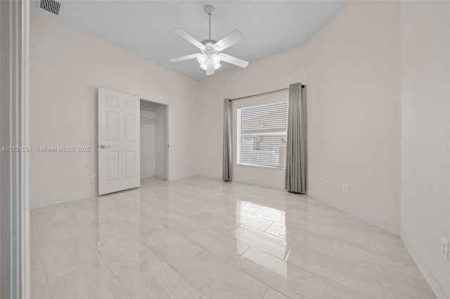 spare room featuring a ceiling fan, visible vents, and baseboards