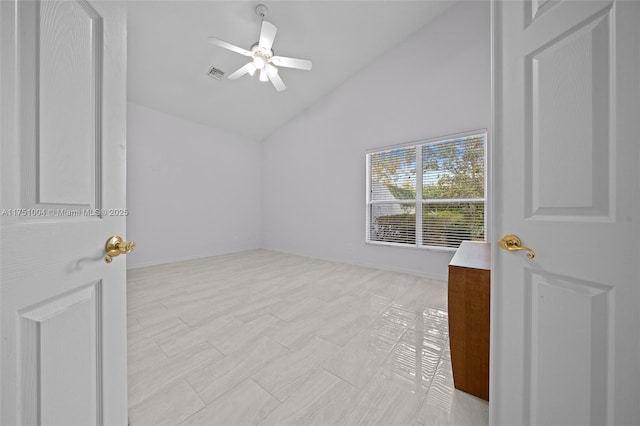 interior space featuring a ceiling fan, lofted ceiling, visible vents, and baseboards