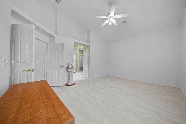 unfurnished bedroom with a ceiling fan, visible vents, vaulted ceiling, and ensuite bathroom