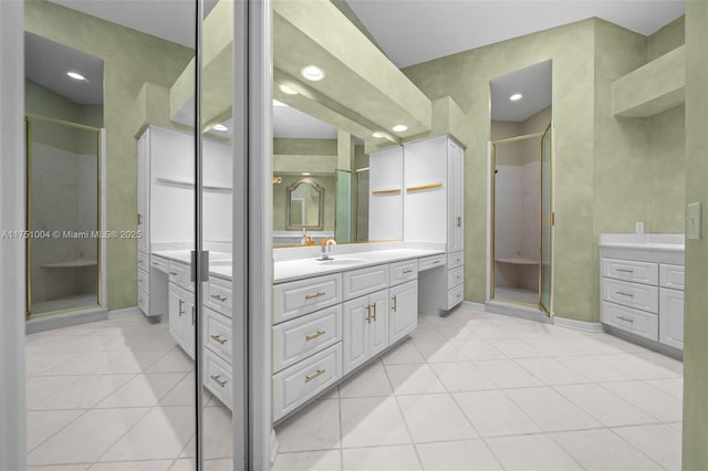 full bathroom featuring baseboards, a shower stall, vanity, and tile patterned floors