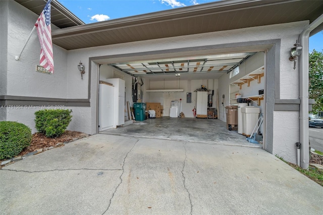 garage with concrete driveway