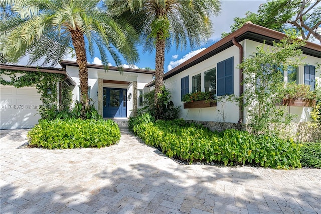 mediterranean / spanish house featuring a garage and stucco siding