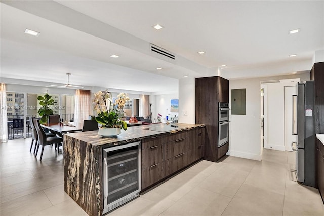 kitchen with appliances with stainless steel finishes, wine cooler, dark brown cabinets, and modern cabinets