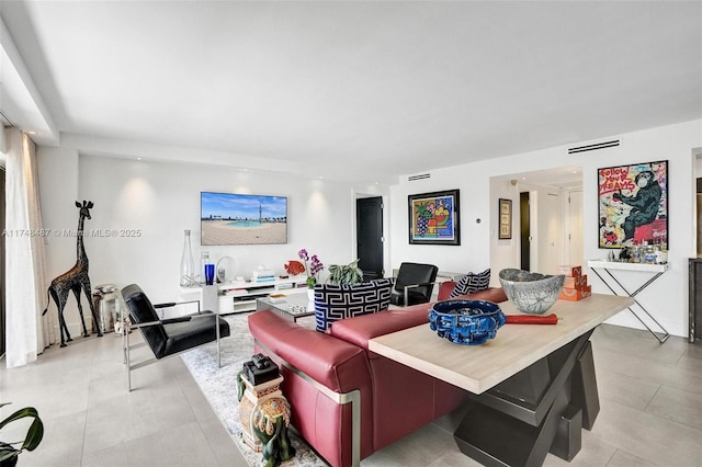 living room featuring light tile patterned floors and visible vents