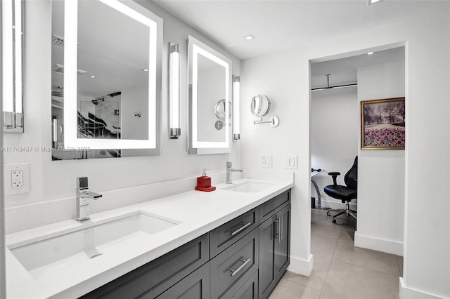 full bath featuring tile patterned flooring, a sink, a shower stall, and double vanity