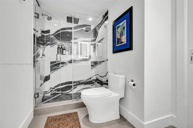 bathroom with toilet, a marble finish shower, baseboards, and tile patterned floors