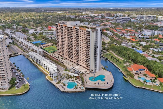 birds eye view of property with a water view and a city view