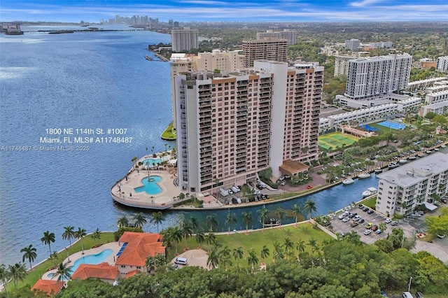 birds eye view of property with a water view and a city view