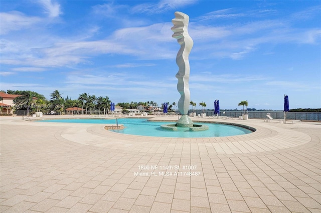 view of swimming pool featuring fence