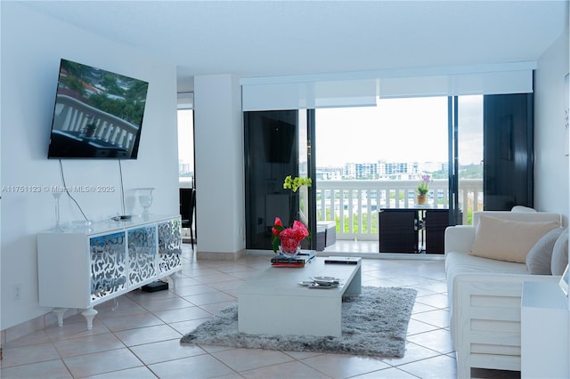 living area featuring expansive windows, light tile patterned flooring, and a city view