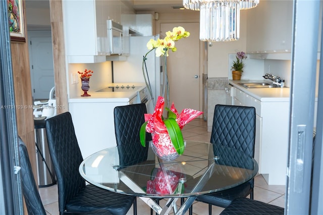 dining space with a notable chandelier and light tile patterned flooring