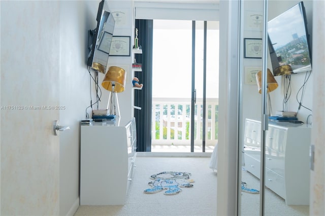 doorway featuring carpet floors and a wall of windows