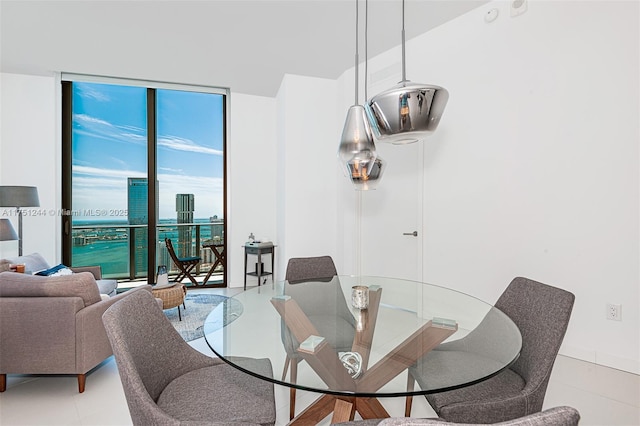 dining space with light tile patterned floors and a view of city