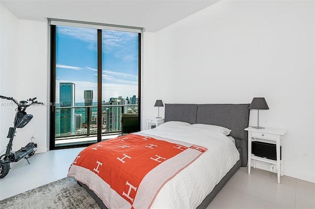 bedroom with a view of city and expansive windows