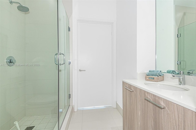 full bathroom featuring tile patterned floors, a shower stall, and vanity