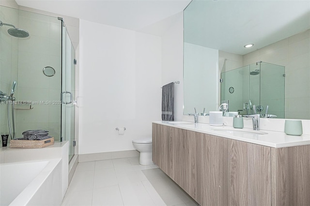 bathroom with tile patterned flooring, a sink, toilet, and a shower stall