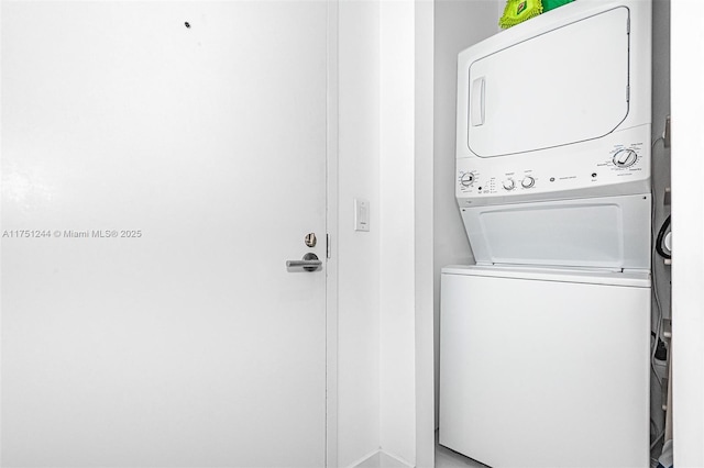 laundry area with stacked washer / dryer and laundry area