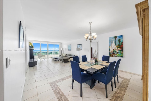 dining area with light tile patterned floors, expansive windows, a chandelier, and baseboards