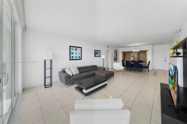 living area with light tile patterned floors and an inviting chandelier