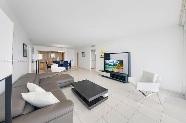 living area with light tile patterned floors, visible vents, and a chandelier