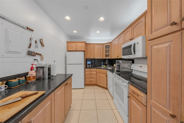 kitchen with white appliances, light tile patterned floors, dark countertops, glass insert cabinets, and recessed lighting