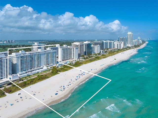 birds eye view of property with a view of city, a beach view, and a water view