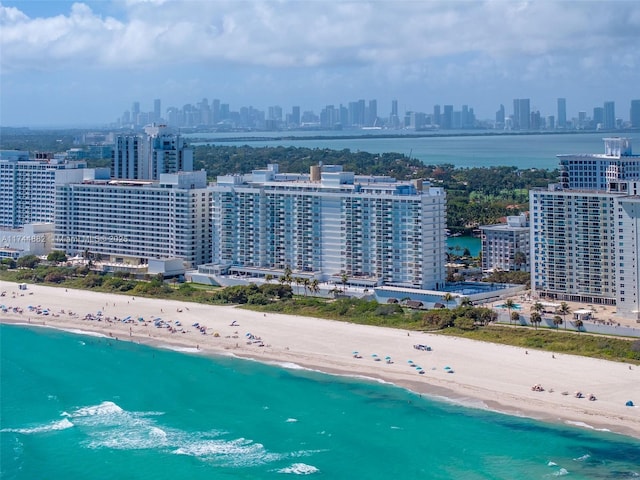 bird's eye view with a water view, a view of city, and a view of the beach