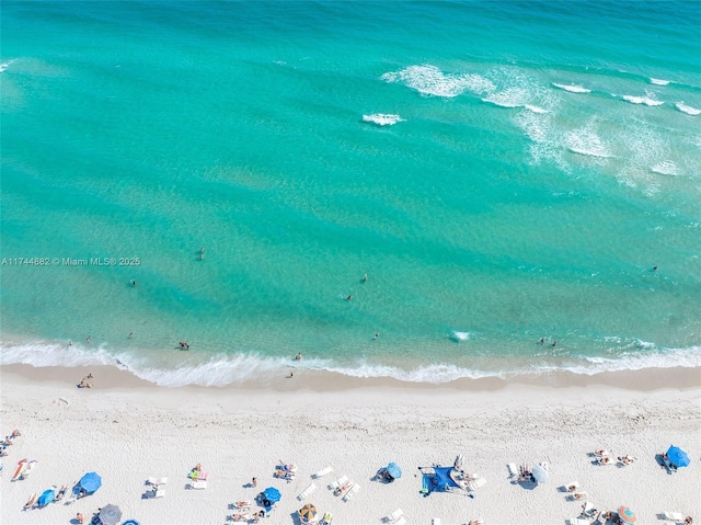 birds eye view of property featuring a view of the beach and a water view