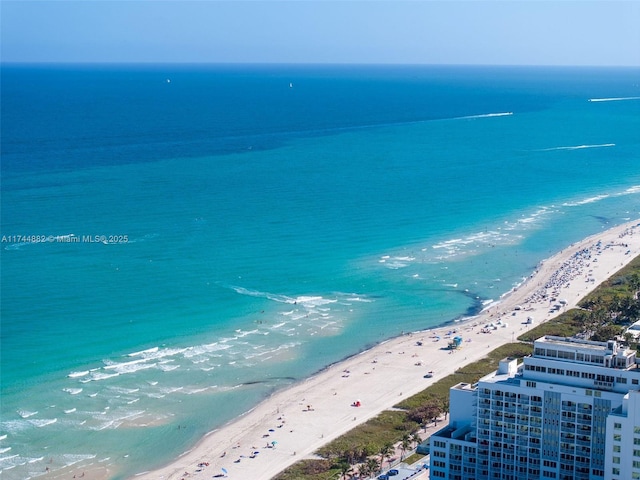 bird's eye view featuring a water view and a view of the beach