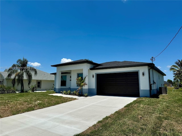 view of front of property with an attached garage, a front lawn, concrete driveway, and stucco siding