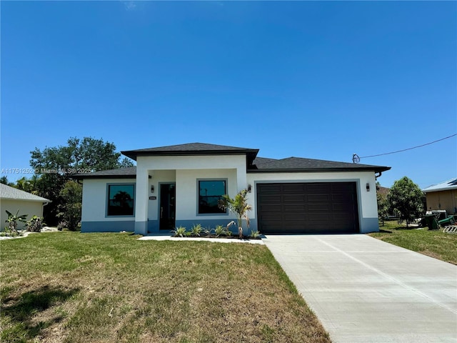 prairie-style home with a front yard, driveway, an attached garage, and stucco siding