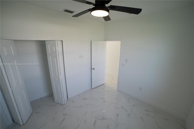 unfurnished bedroom with marble finish floor, baseboards, visible vents, and a closet