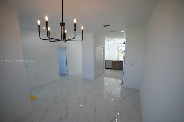 unfurnished room featuring marble finish floor and baseboards