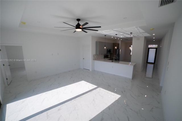 unfurnished living room featuring marble finish floor, visible vents, a sink, and recessed lighting