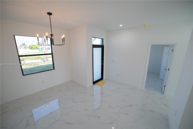 empty room featuring marble finish floor, baseboards, an inviting chandelier, and recessed lighting