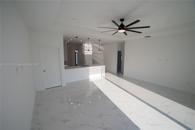 unfurnished room featuring visible vents, a raised ceiling, marble finish floor, a sink, and recessed lighting