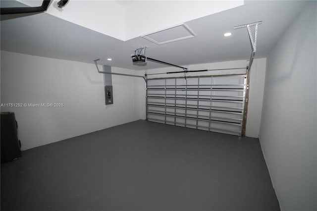 garage with recessed lighting, electric panel, and a garage door opener