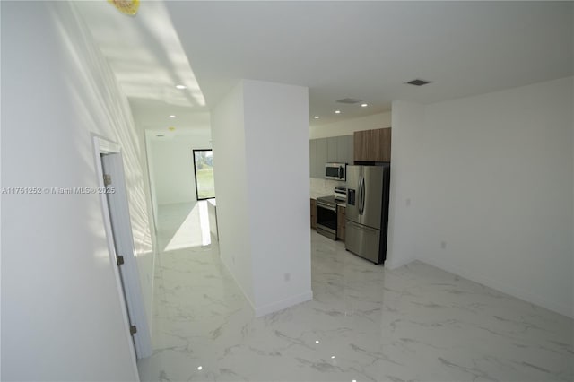 corridor featuring marble finish floor, baseboards, visible vents, and recessed lighting